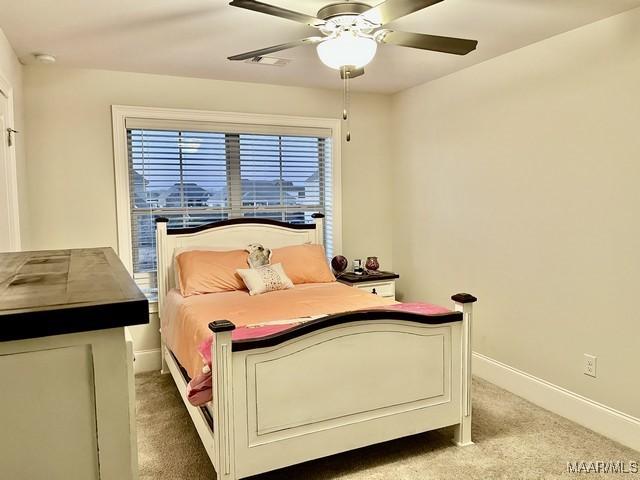 carpeted bedroom featuring ceiling fan