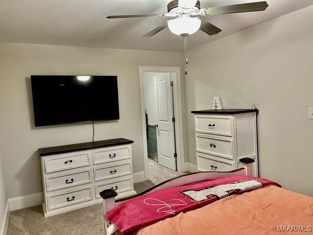 bedroom featuring ceiling fan and light carpet