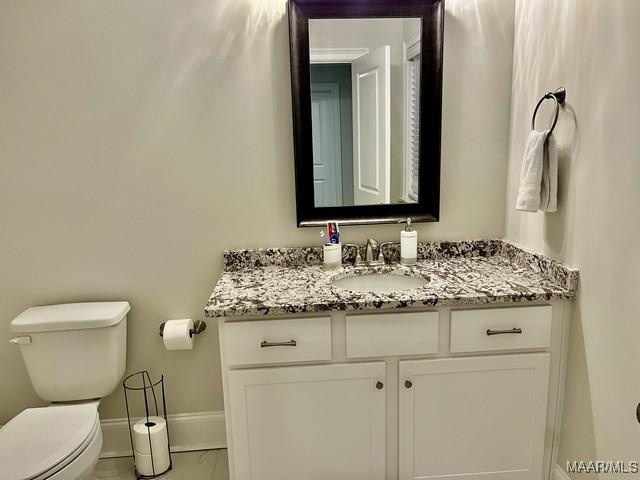 bathroom featuring vanity and toilet