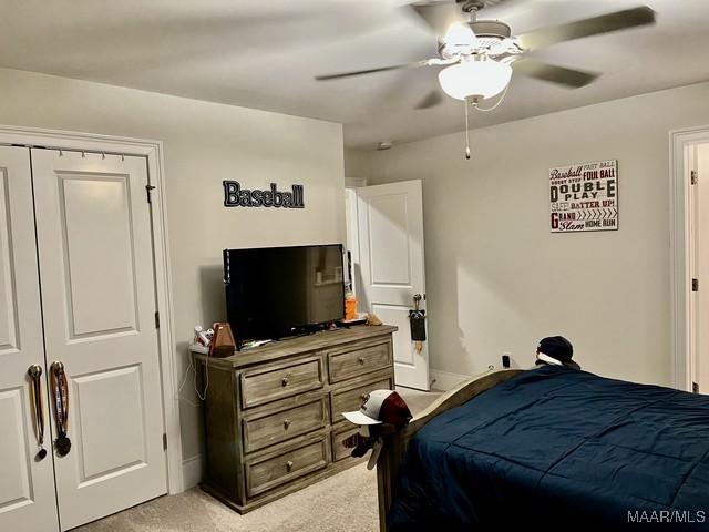 bedroom with ceiling fan and light colored carpet