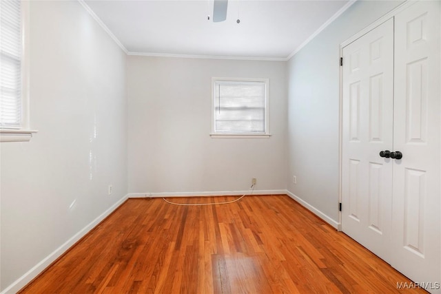 unfurnished bedroom featuring multiple windows, light hardwood / wood-style flooring, and ornamental molding