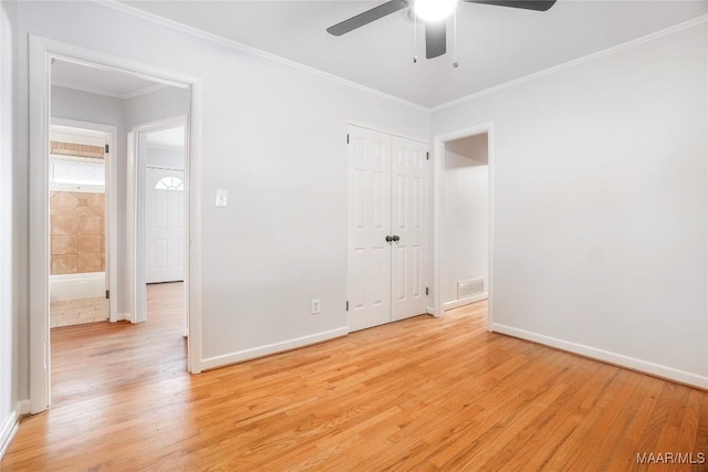 unfurnished bedroom featuring ceiling fan, ornamental molding, a closet, and light hardwood / wood-style flooring