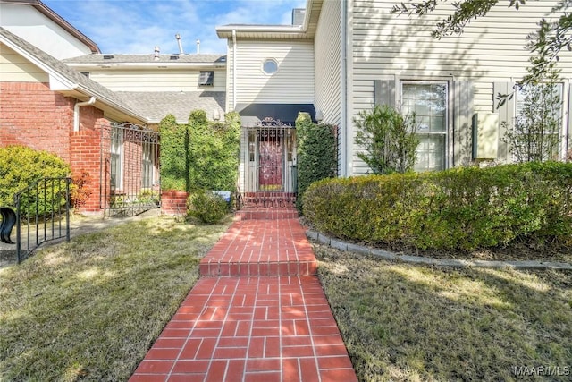 doorway to property featuring a yard