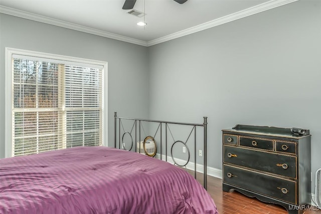 bedroom featuring wood-type flooring, ornamental molding, and ceiling fan