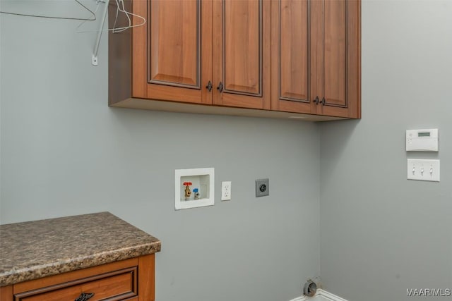 laundry area with cabinets, hookup for an electric dryer, and hookup for a washing machine