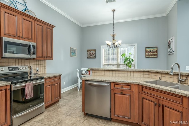 kitchen with appliances with stainless steel finishes, sink, decorative backsplash, crown molding, and light stone countertops