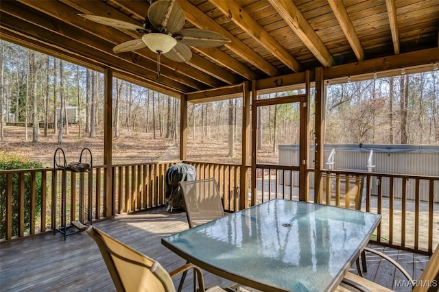 sunroom / solarium featuring ceiling fan