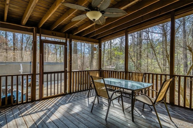 unfurnished sunroom featuring ceiling fan