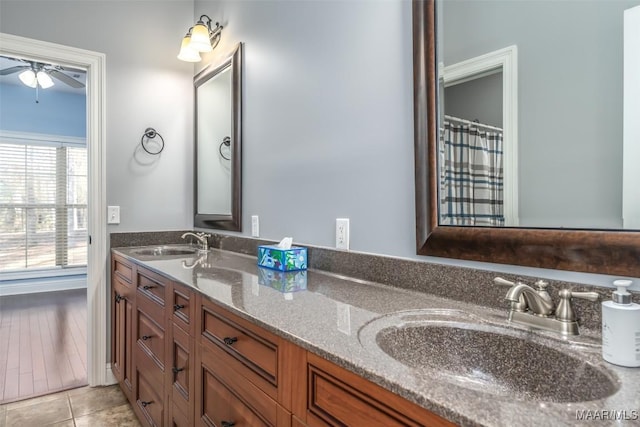 bathroom with ceiling fan, vanity, and tile patterned flooring