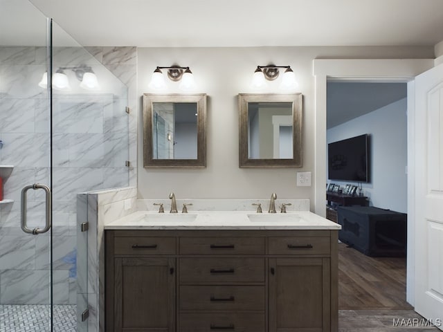 bathroom with vanity, wood-type flooring, and walk in shower