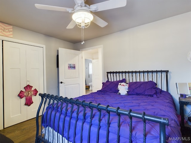 bedroom featuring dark hardwood / wood-style flooring, a closet, and ceiling fan