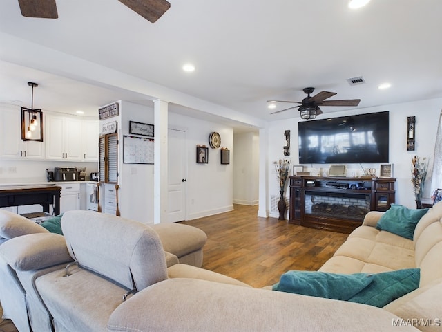 living room with hardwood / wood-style flooring and ceiling fan