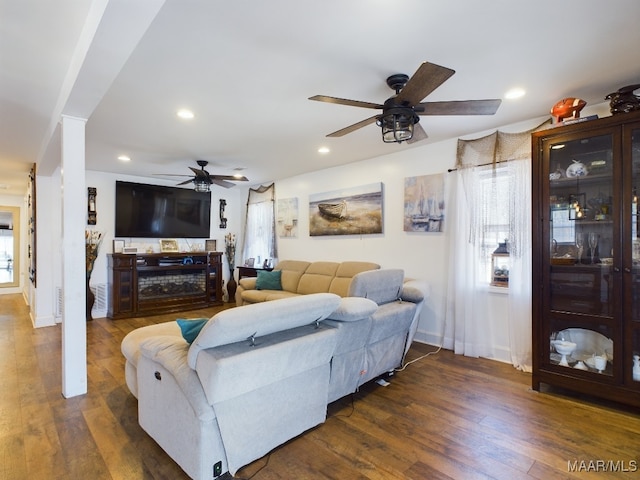 living room with plenty of natural light, dark hardwood / wood-style floors, and ceiling fan