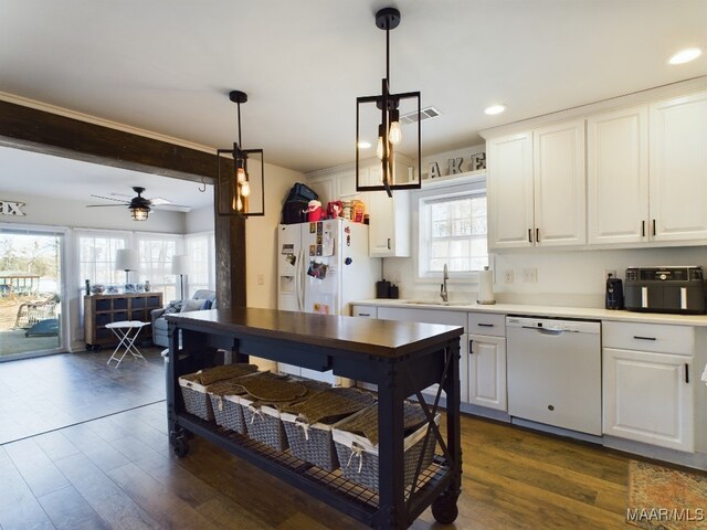 kitchen with sink, white cabinets, and white appliances