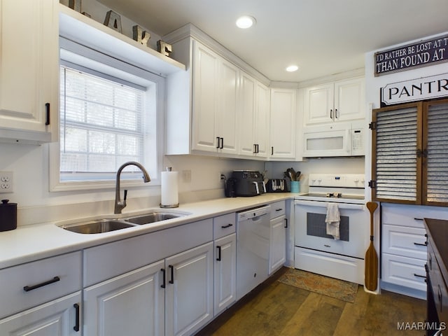 kitchen featuring white cabinetry, sink, dark wood-type flooring, and white appliances