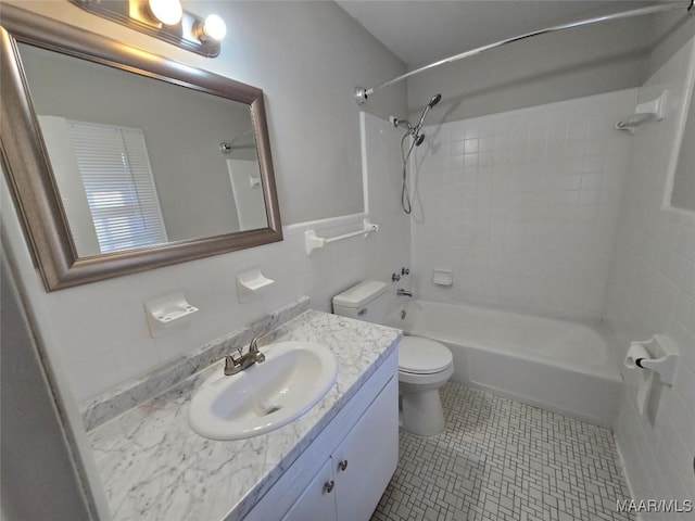 full bathroom featuring vanity, tiled shower / bath combo, tile patterned floors, and toilet