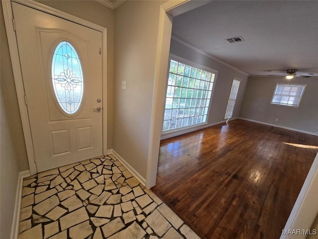 entryway with hardwood / wood-style flooring, ceiling fan, and ornamental molding