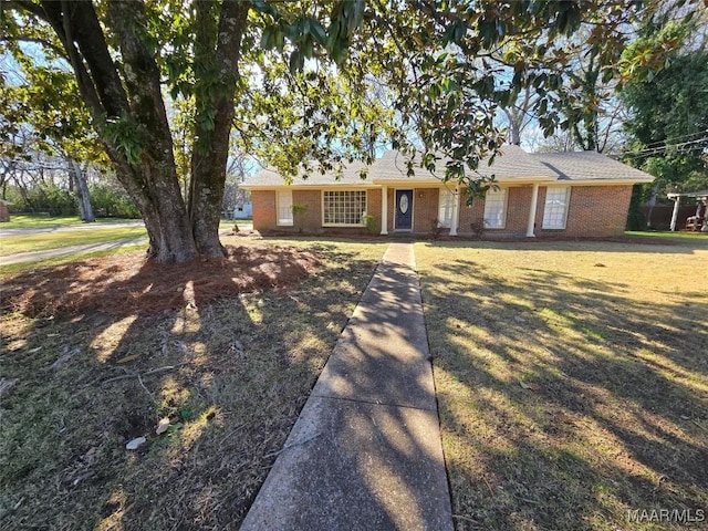 ranch-style home featuring a front yard and brick siding