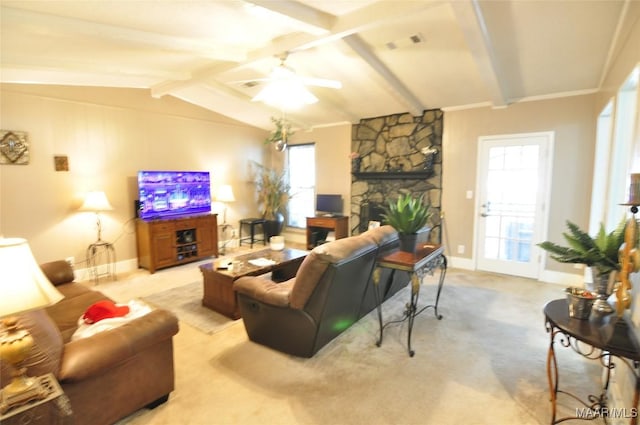 carpeted living room featuring vaulted ceiling with beams, a fireplace, and ceiling fan