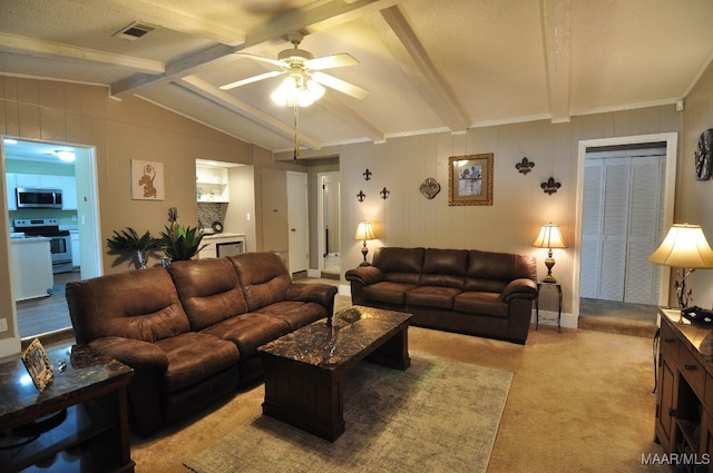 living room featuring lofted ceiling with beams, light colored carpet, and ceiling fan