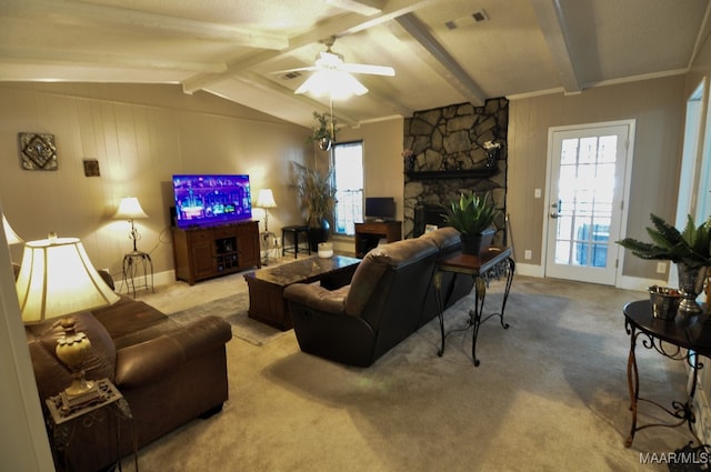 living room with a stone fireplace, carpet floors, lofted ceiling with beams, and ceiling fan