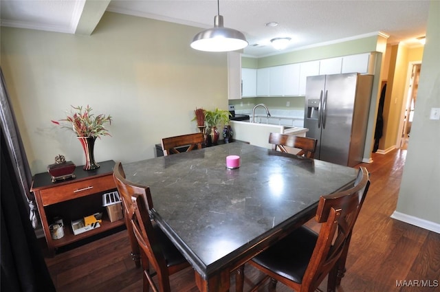 dining area with crown molding and dark wood-type flooring