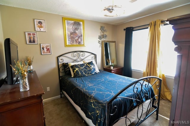 bedroom with multiple windows and dark colored carpet