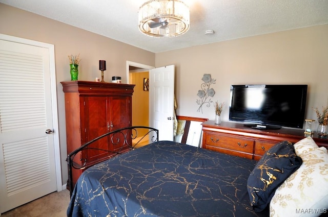 carpeted bedroom featuring a textured ceiling