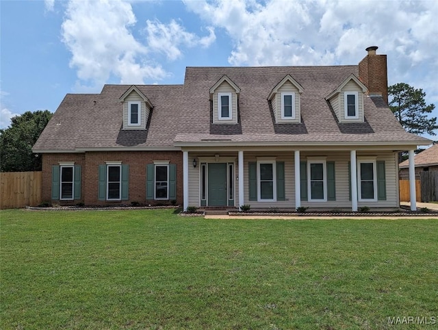 cape cod house featuring a front yard and covered porch