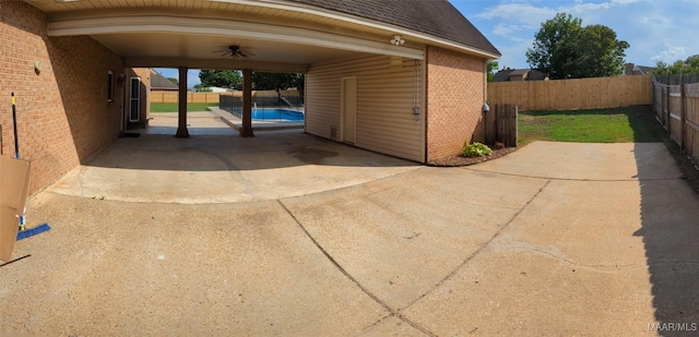 view of vehicle parking featuring a carport and ceiling fan