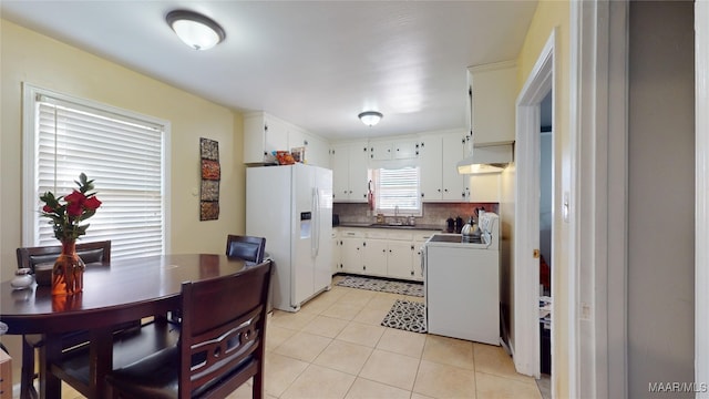 kitchen with sink, white cabinetry, tasteful backsplash, white refrigerator with ice dispenser, and stove