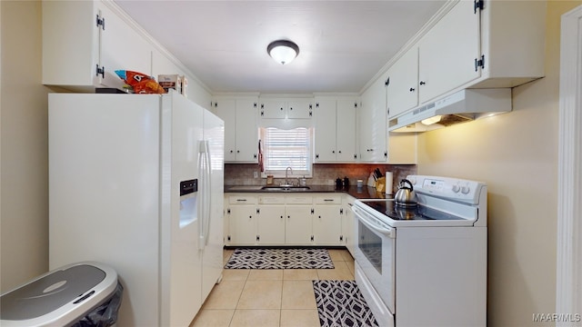 kitchen featuring sink, white appliances, light tile patterned floors, tasteful backsplash, and white cabinets