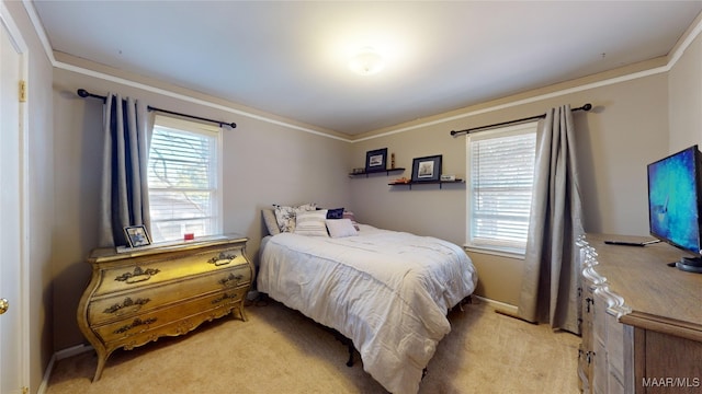 bedroom with light colored carpet, ornamental molding, and multiple windows