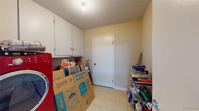 laundry room with washer / clothes dryer, light tile patterned floors, and cabinets