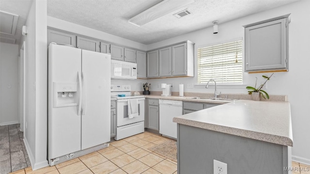 kitchen with white appliances, sink, a textured ceiling, and gray cabinetry