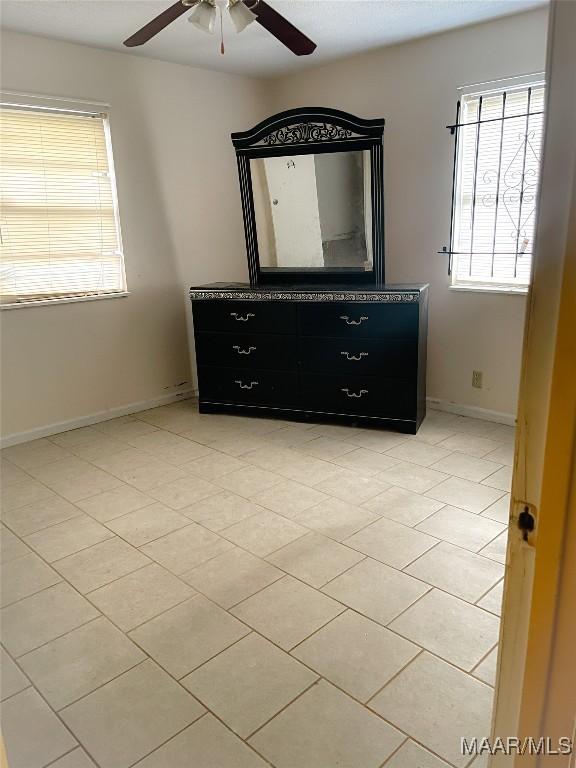 unfurnished bedroom featuring ceiling fan