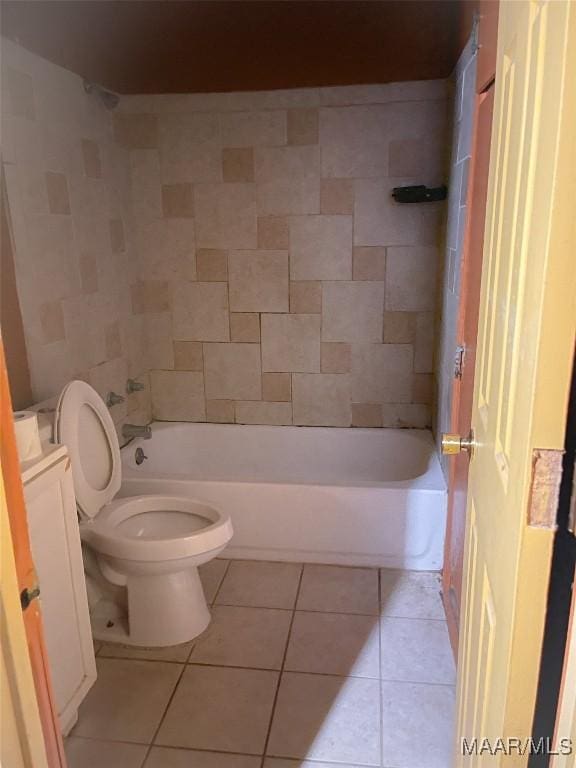 full bathroom featuring tiled shower / bath, tile patterned floors, and toilet