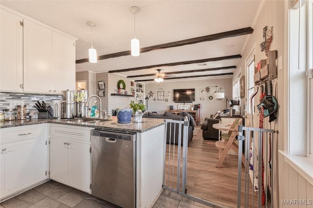 kitchen featuring white cabinetry, sink, dark stone counters, stainless steel dishwasher, and kitchen peninsula