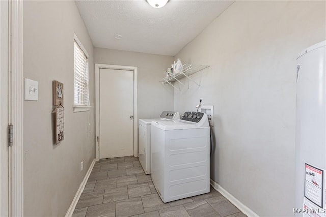 laundry area with washer and dryer and a textured ceiling