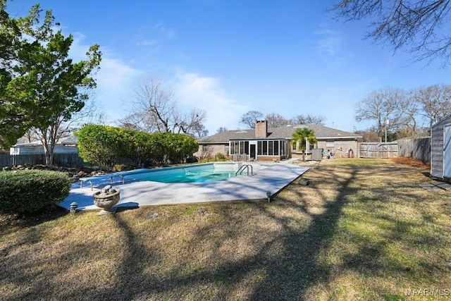 view of swimming pool with a patio, a sunroom, and a yard