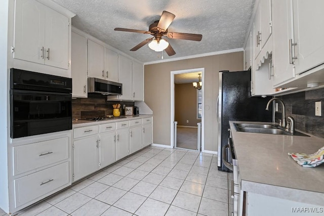 kitchen featuring appliances with stainless steel finishes, white cabinetry, sink, ceiling fan, and crown molding