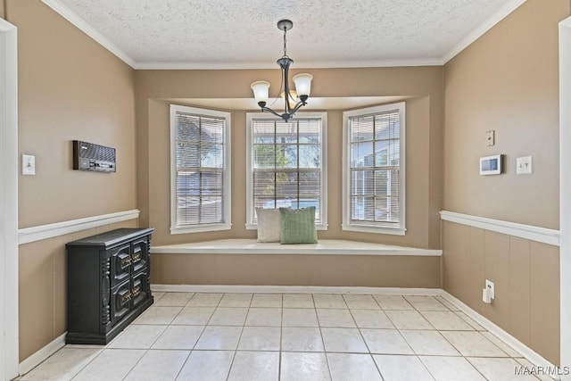 unfurnished dining area featuring a notable chandelier, ornamental molding, and a textured ceiling