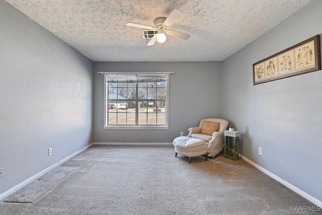 unfurnished room featuring a textured ceiling, ceiling fan, and carpet