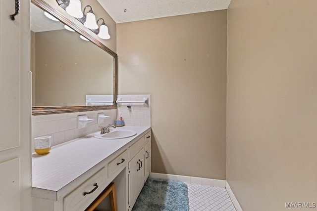 bathroom with vanity, tile patterned flooring, decorative backsplash, and a textured ceiling