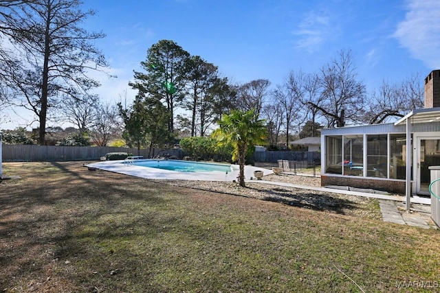 view of yard featuring a fenced in pool and a sunroom