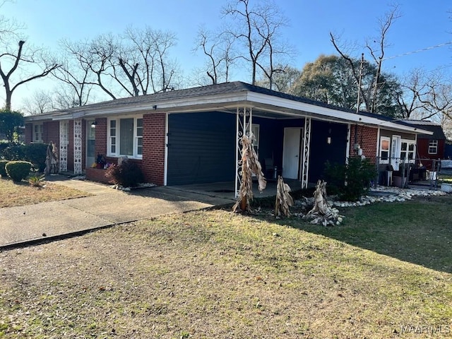 ranch-style home with a carport and a front yard