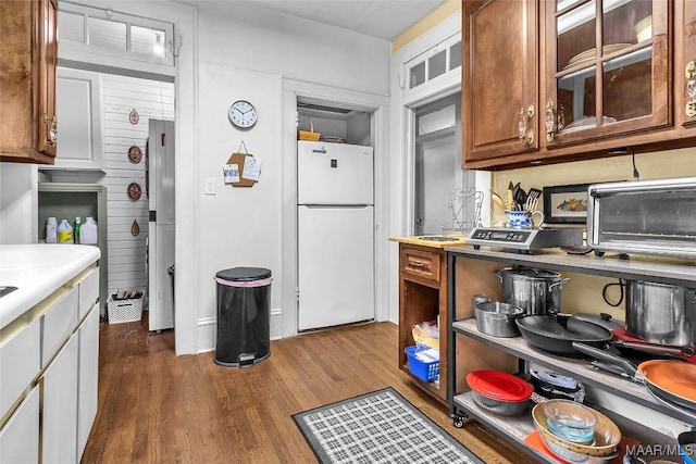 kitchen with hardwood / wood-style flooring and white fridge