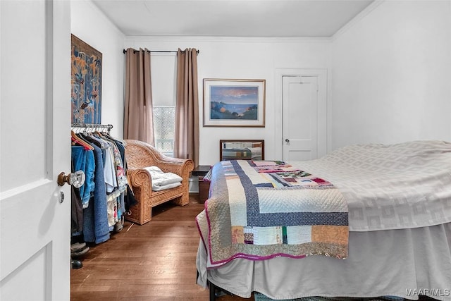 bedroom featuring ornamental molding and dark hardwood / wood-style flooring