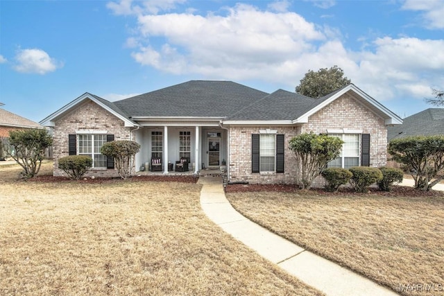 ranch-style house with covered porch and a front lawn