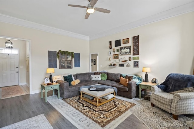 living room with crown molding, ceiling fan with notable chandelier, and hardwood / wood-style flooring